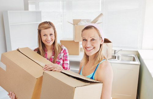 People loading furniture into a removal truck